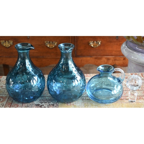 56 - A Nina Campbell blue glass jug to/w two moulded blue glass carafes (3)