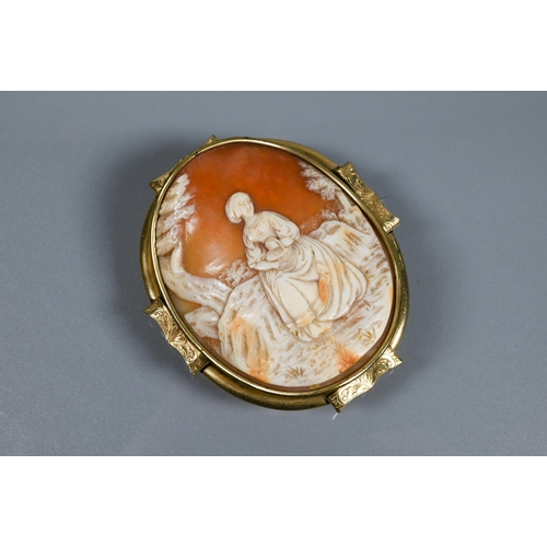 213 - A large Victorian carved shell cameo brooch featuring maiden seated in a landscape, yellow metal mou... 