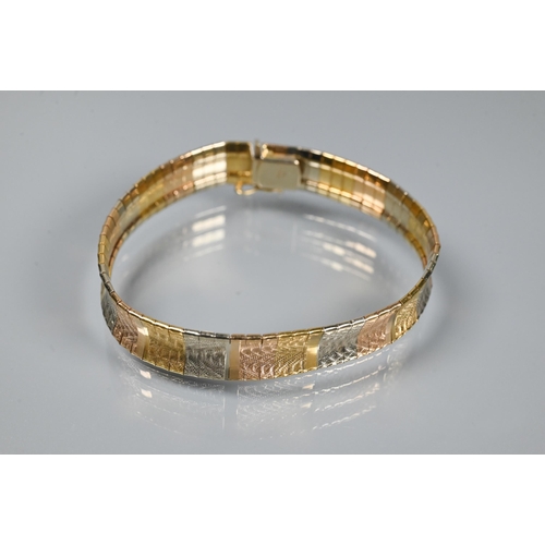 293 - A modern tri-coloured bracelet formed of etched rectangular links of yellow, white and rose metal, c... 