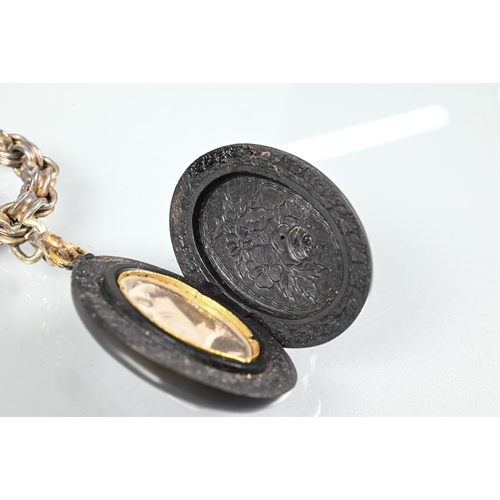 294 - A Victorian Whitby jet oval locket with cameo carved in high relief to front, and opening to reveal ... 