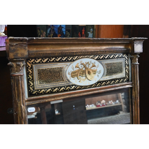 868 - A Regency gilt framed trumeau reverse gilt on glass panel mirror, 98 cm h x 62 cm w