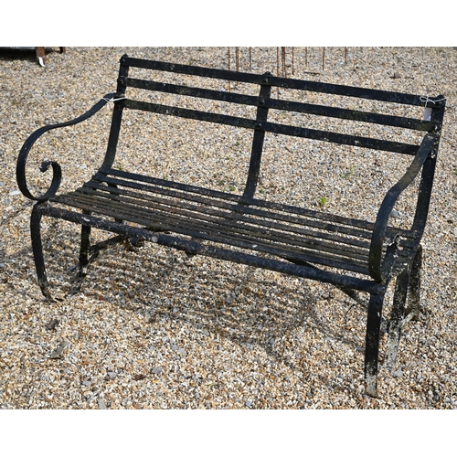 900 - An antique black-painted wrought iron strap-work bench, 124 cm wide