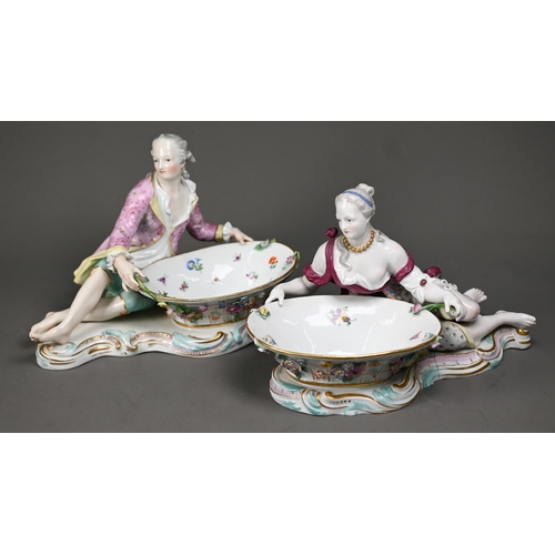 572 - A pair of 19th century Meissen bonbon dishes modelled as floral painted and encrusted baskets held b... 