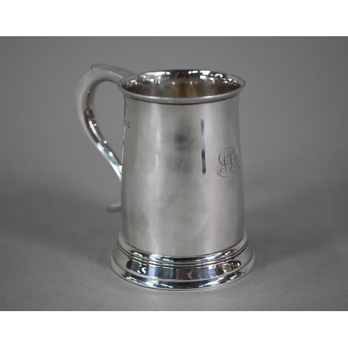 103 - A silver half-pint mug in the Georgian manner, with scroll handle and moulded foot-rim, Blackmore &a... 