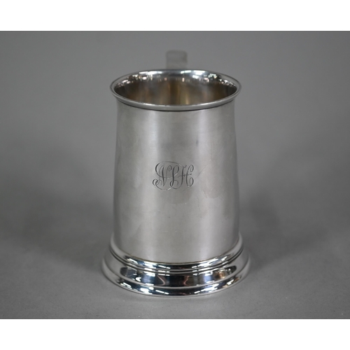 103 - A silver half-pint mug in the Georgian manner, with scroll handle and moulded foot-rim, Blackmore &a... 