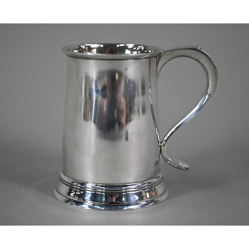 103 - A silver half-pint mug in the Georgian manner, with scroll handle and moulded foot-rim, Blackmore &a... 