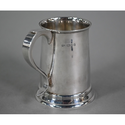 103 - A silver half-pint mug in the Georgian manner, with scroll handle and moulded foot-rim, Blackmore &a... 