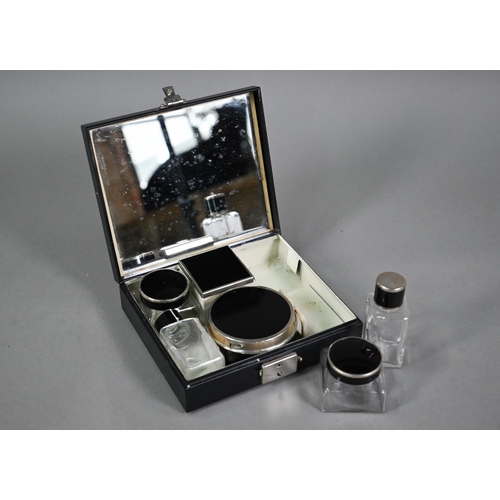 11 - An Art Deco enamelled base-metal small travelling toilet set, to/w an electroplated ashtray construc... 