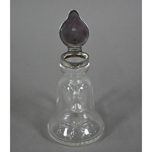 116 - A glass whisky noggin of bell-form with drawn handle and star-cut base, hinged silver top by Hukin &... 