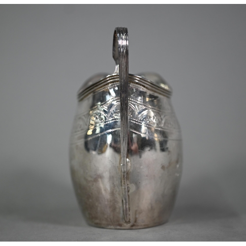 119 - A George III silver cream jug with reeded rim and strap handle and engraved decoration, Peter & ... 