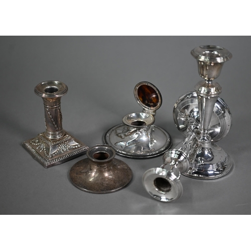 128 - A quantity of loaded silver items including candlesticks, desk calendar, inkwells, photograph frames... 