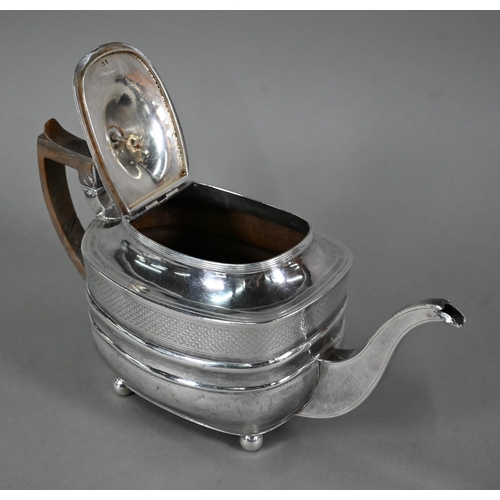 130 - A Regency silver teapot of oblong form  with diaper engraving and horn handle, on ball feet, Thomas ... 