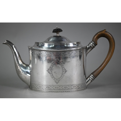 132 - An Edwardian Sheraton revival oval silver teapot with engraved decoration and wooden handle and fini... 