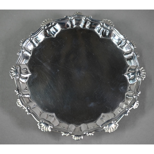 133 - An early George III silver card salver with shell and scroll moulded rim, on three hoof feet, Ebenez... 