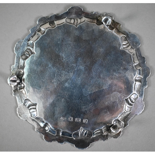 133 - An early George III silver card salver with shell and scroll moulded rim, on three hoof feet, Ebenez... 