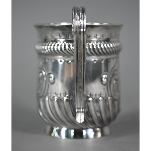 135 - A late Victorian loving cup in the Carolean manner, with reeded strap handles and embossed decoratio... 