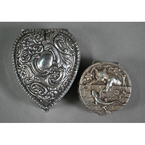 138 - An Edwardian circular silver small box, the cover finely embossed and chased with a cat hunting a li... 