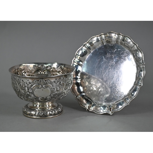 141 - An Edwardian silver rose bowl with embossed and chased floral and scroll decoration, on stemmed foot... 