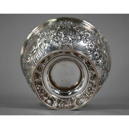 141 - An Edwardian silver rose bowl with embossed and chased floral and scroll decoration, on stemmed foot... 