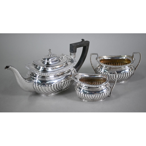 161 - An Edwardian heavy quality three-piece tea service of half-reeded oblong form with composite handle,... 