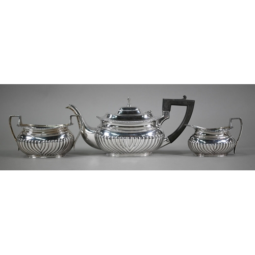 161 - An Edwardian heavy quality three-piece tea service of half-reeded oblong form with composite handle,... 