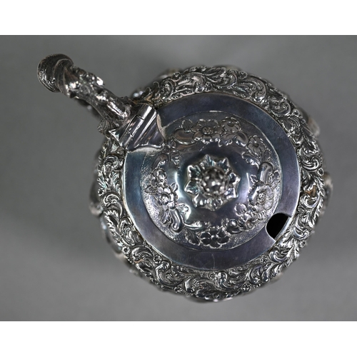 176 - A good George IV silver mustard with hinged cover, scroll handle and stemmed foot, richly embossed a... 