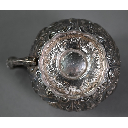 176 - A good George IV silver mustard with hinged cover, scroll handle and stemmed foot, richly embossed a... 