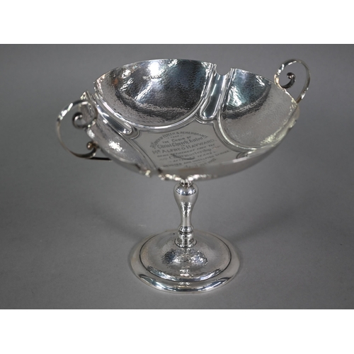 184 - An Edwardian silver comport in the Arts and Crafts manner, with twin scroll handles and part-planish... 