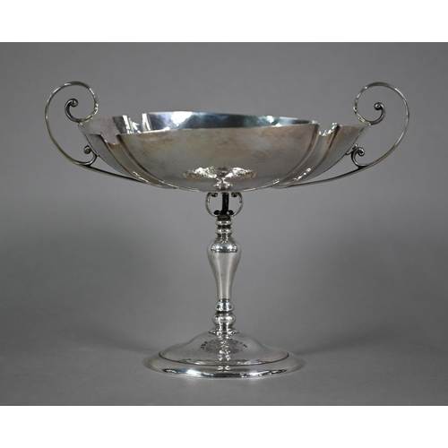 184 - An Edwardian silver comport in the Arts and Crafts manner, with twin scroll handles and part-planish... 