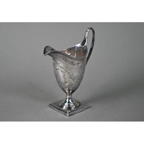 195 - A George III silver urn-shaped cream jug in the Adam manner, with beaded rim, engraved decoration an... 