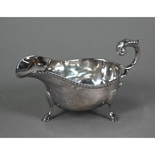 196 - A US market (Tiffany) Irish silver sauce-boat in Georgian taste, with gadrooned rim, scroll handle a... 