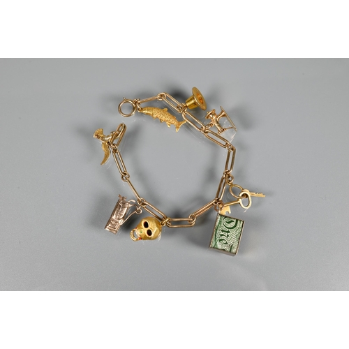 200 - A 9ct yellow gold charm bracelet formed of elongated links with eight various charms attached includ... 