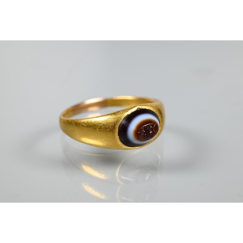 202 - A Roman gold ring set with banded agate intaglio carved with indistinct figures, size U 1/2 (resized... 