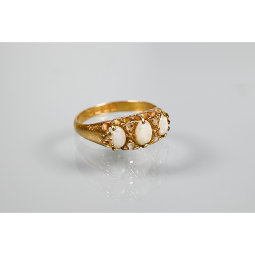 203 - An antique 18ct yellow gold ring set with three graduated opals with rose cut diamonds, size L to/w ... 