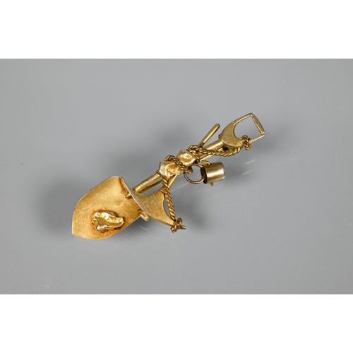 205 - A gold 'prospector' brooch, in the form of crossed spade and pickaxe, suspending a bucket and w... 