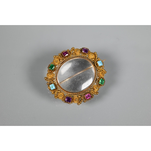 206 - A Victorian gilt metal oval brooch with filigree decoration and set with semi-precious stones/paste,... 