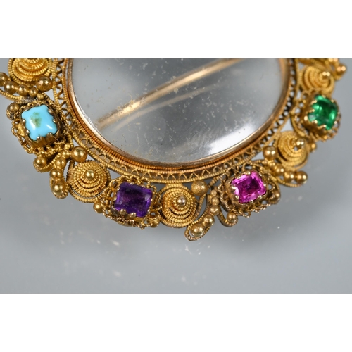 206 - A Victorian gilt metal oval brooch with filigree decoration and set with semi-precious stones/paste,... 