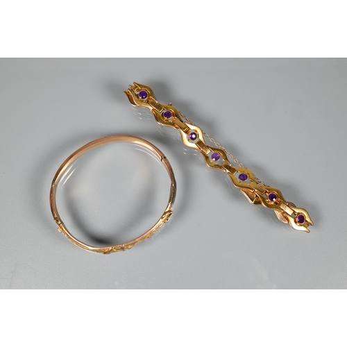 207 - A yellow metal bracelet stamped 9ct formed of open links with bezel set amethysts to the centre of e... 