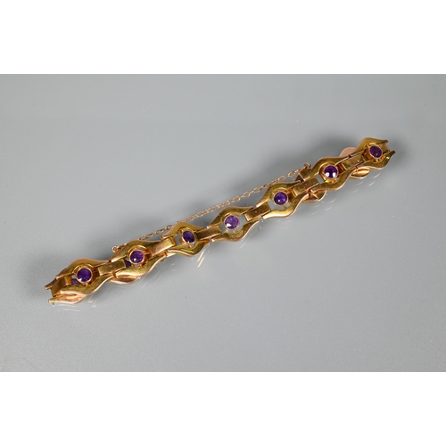 207 - A yellow metal bracelet stamped 9ct formed of open links with bezel set amethysts to the centre of e... 