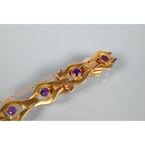 207 - A yellow metal bracelet stamped 9ct formed of open links with bezel set amethysts to the centre of e... 