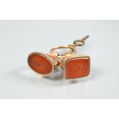 209 - Two gilt metal fob seals set cornelian intaglios with monograms, a smaller example set with hardston... 