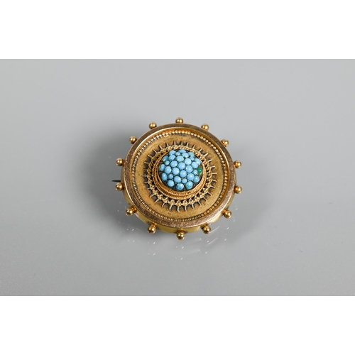 211 - A Victorian target brooch with beaded edge and rope and wirework decoration, the central boss set ov... 