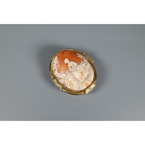 213 - A large Victorian carved shell cameo brooch featuring maiden seated in a landscape, yellow metal mou... 