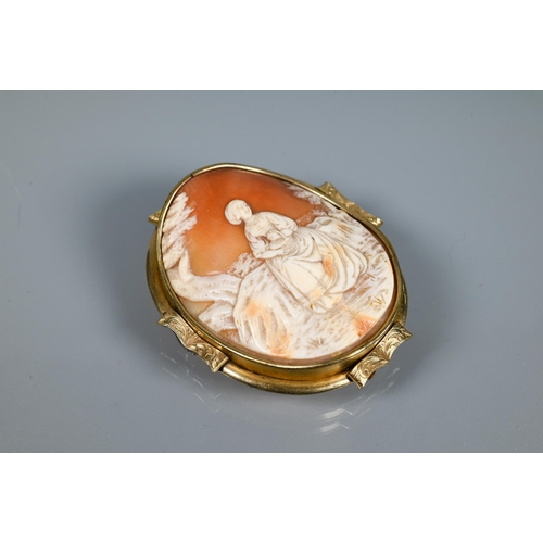 213 - A large Victorian carved shell cameo brooch featuring maiden seated in a landscape, yellow metal mou... 