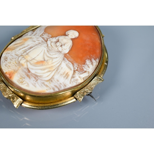 213 - A large Victorian carved shell cameo brooch featuring maiden seated in a landscape, yellow metal mou... 