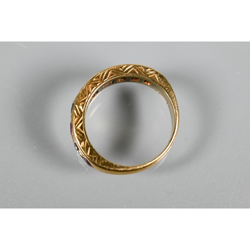 216 - An antique 18ct yellow gold ring set with nine graduated alternate set ruby and diamonds, in carved ... 