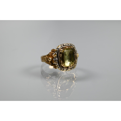 227 - A Georgian memento mori ring with carved flower shoulders and cushion cut foil-backed peridot to cen... 