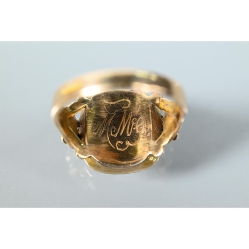 227 - A Georgian memento mori ring with carved flower shoulders and cushion cut foil-backed peridot to cen... 