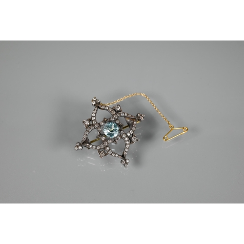 234 - A Victorian brooch, the central round zircon surrounded by an old cut diamond set shaped Gothic styl... 