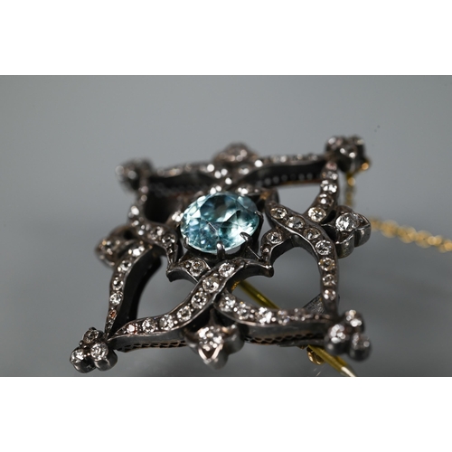 234 - A Victorian brooch, the central round zircon surrounded by an old cut diamond set shaped Gothic styl... 